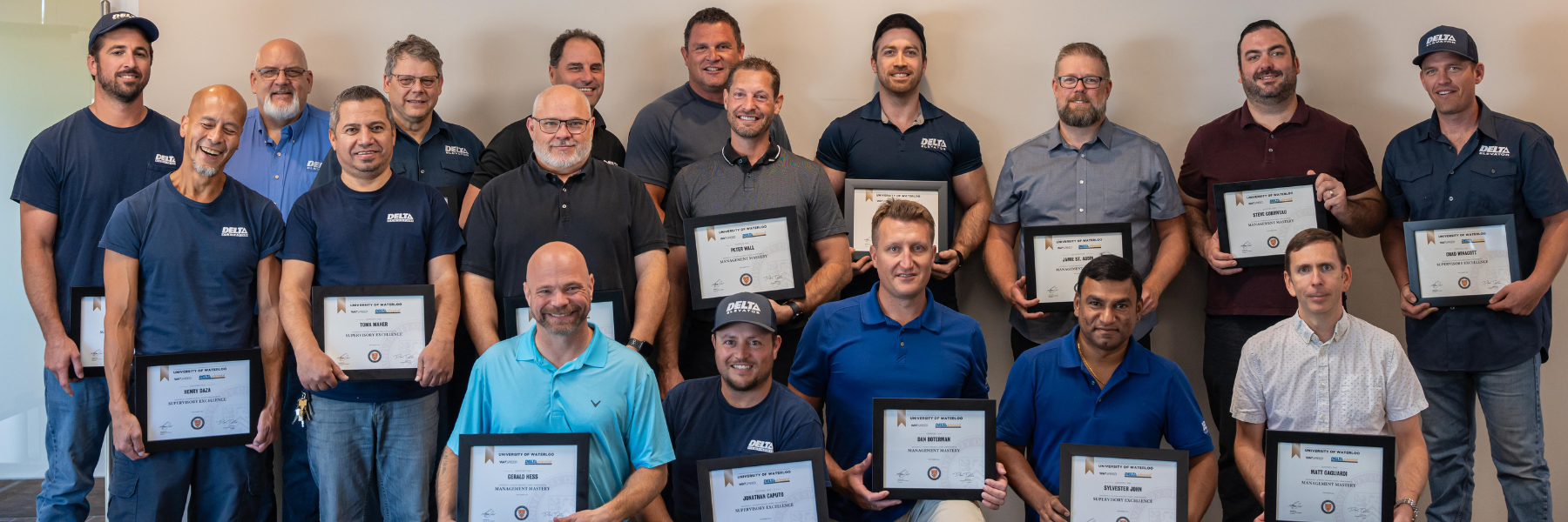 Delta Elevate graduates standing with their certificates