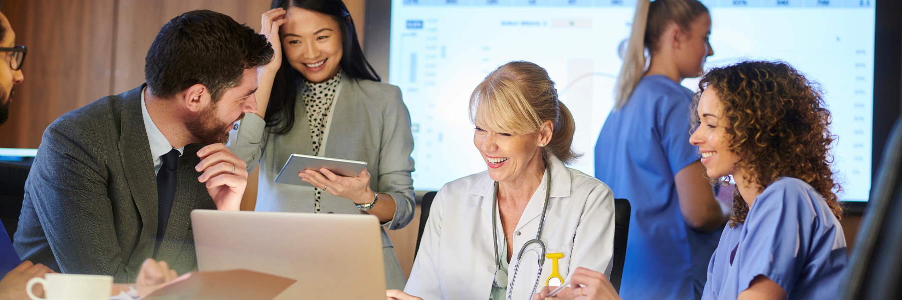 Health professionals on a laptop in a conference room
